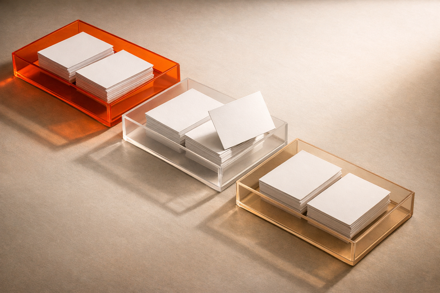 Editorial arrangement: three acrylic trays on a neutral table, each filled with blank index cards. Orange tray is most prominent; others fade from orange to white. A single card lies uneasily on the divide between trays, suggesting ambiguity in data risk. Cinematic, no text or people.